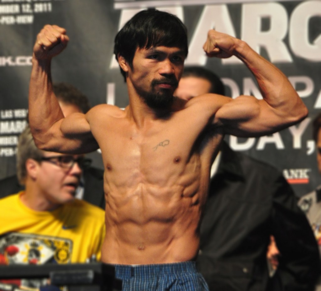 Manny Pacquiao flexes his muscles after making weight for his bout against Juan Manuel Marquez. Pacquiao came in at 143 pounds. Photo by Francis T.J. Ochoa