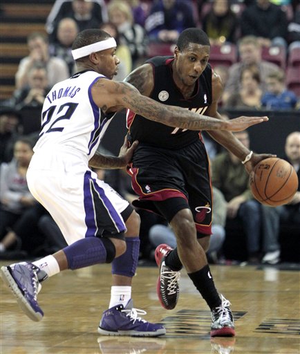 Miami Heat guard Mario Chalmers, right, drives against Sacramento Kings guard Isaiah Thomas during the first quarter of an NBA basketball game in Sacramento, Calif., Saturday, Jan. 12, 2013. Chalmers scored 34 points to lead the Heat in a 128-99 win over the Kings. AP