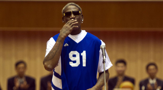 Dennis Rodman blows a kiss to North Korean leader Kim Jong Un, seated above in the stands, before an exhibition basketball game with US and North Korean players at an indoor stadium in Pyongyang, North Korea on Wednesday, Jan. 8, 2014. AP
