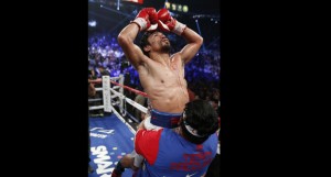 Manny Pacquiao, of the Philippines, celebrates his unanimous decision over Timothy Bradley in their WBO welterweight title boxing fight Saturday, April 12, 2014, in Las Vegas. AP