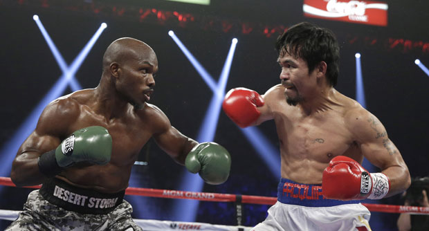 Timothy Bradley, left, trades blows with Manny Pacquiao, of the Philippines, in their WBO welterweight title boxing bout Saturday, April 12, 2014, in Las Vegas. AP