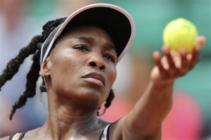 Venus Williams of the US serves the ball during the first round match of the French Open tennis tournament against Switzerland's Belinda Bencic at the Roland Garros stadium, in Paris, France, Sunday, May 25, 2014. (AP Photo/David Vincent)