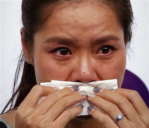 Chinese tennis player Li Na wipes her tears during a press conference to announce her retirement in Beijing, China, Sunday, Sept. 21, 2014. AP