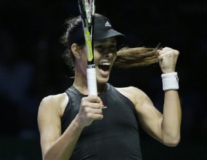 Serbia's Ana Ivanovic celebrates after winning a point against Romania's Simona Halep during their singles match at the WTA tennis finals in Singapore, Friday, Oct. 24, 2014. AP