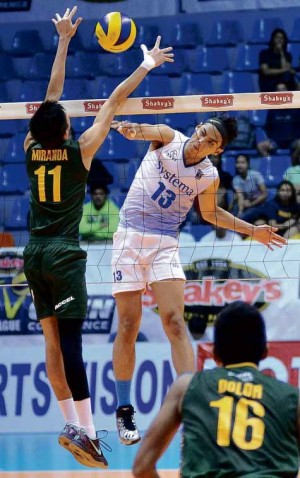 CHRISTIAN Arbasto of Systema hammers one in off Clifford Miranda of FEU in yesterday’s match at Filoil Flying V Arena. AUGUST DELA CRUZ