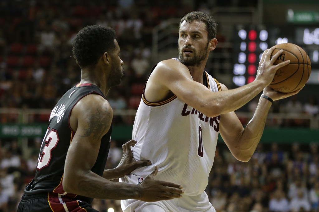 Cleveland Cavaliers' Kevin Love, right, moves the ball under pressure from Miami Heat's Shawne Williams during a NBA preseason basketball game that's part of the NBA Global Games in Rio de Janeiro, Brazil, Saturday, Oct. 11, 2014. AP