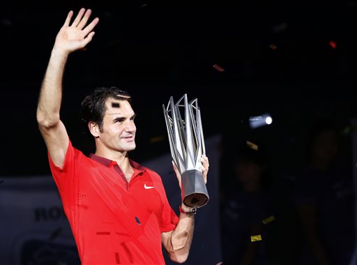 Roger Federer of Switzerland poses with the trophy during the awards ceremony after winning the men's singles final against Gilles Simon of France at the Shanghai Masters Tennis Tournament in Shanghai, China, Sunday, Oct. 12, 2014. AP