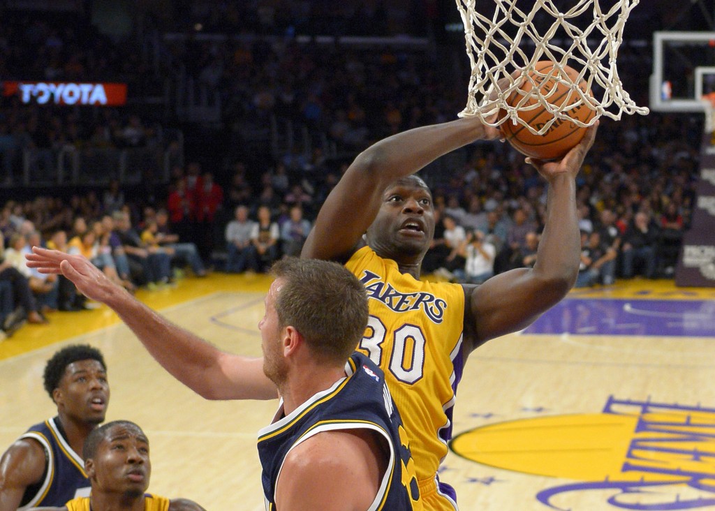 Los Angeles Lakers forward Julius Randle, right, puts up a shot as Utah Jazz forward Steve Novak defends during the second half of a preseason NBA basketball game, Sunday, Oct. 19, 2014, in Los Angeles.  The Lakers on 98-91. AP