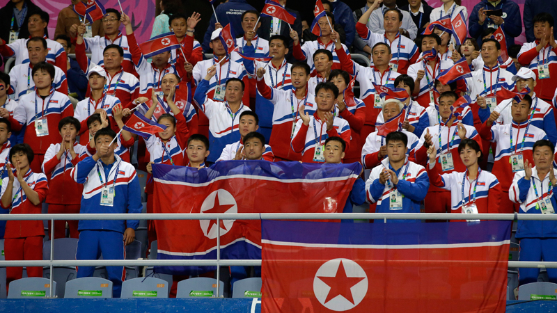North Korean soccer fans wave their national flag and watch the final match played between North and South Korea at the 17th Asian Games in Incheon, South Korea, Thursday, Oct. 2, 2014.  The man seen as North Korea's No. 2 and other senior officials plan to travel to the South on Saturday for the close of the Asian Games sporting event, South Korean officials said, a rare visit by Pyongyang's inner circle that will include a meeting with Seoul's top official for North Korean affairs. (AP Photo/Dita Alangkara)