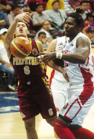 SAN BEDA’S Ola Adeogun (right) foils a drive by Perpetual Help’s Earl Thompson in yesterday’s game.  RODEL ROTONI