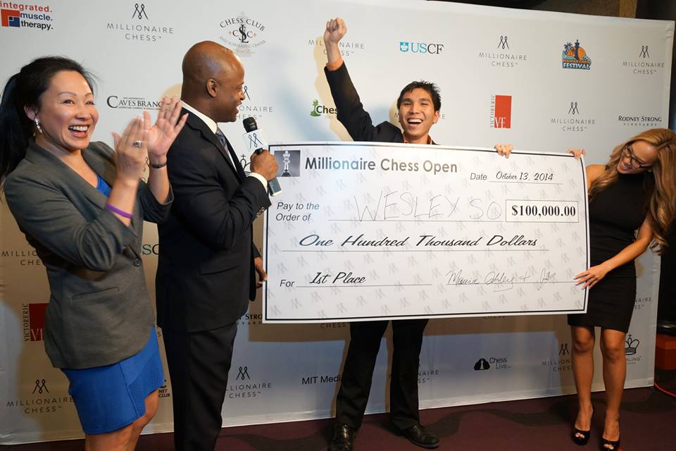 Wesley So exults after receiving from organizer Maurice Ashley a replica of the $100,000 first prize check in the Millionaire Chess Open at Planet Hollywood. PHOTO BY PAUL TRUONG