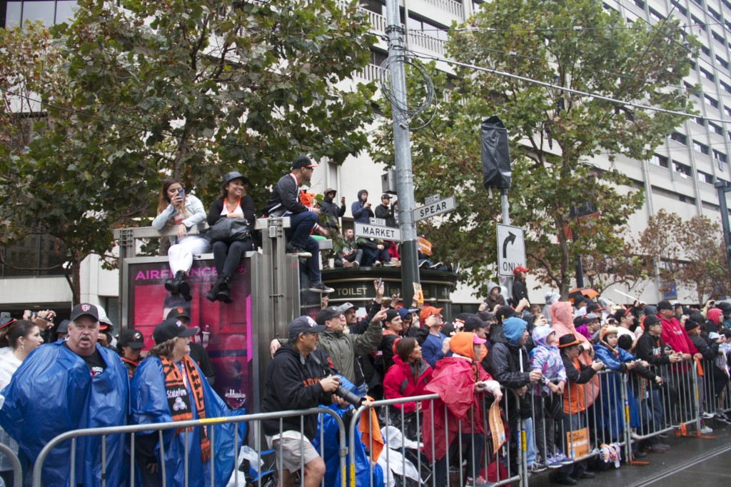 Fans waiting in the rain for the San Francisco Giants victory parade. PHOTOS BY MANDY CHAVEZ