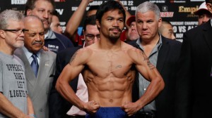 WBO welterweight champion Manny Pacquiao of the Philippines, poses for photos during the weigh-in for his welterweight title fight against WBO junior welterweight champion Chris Algieri of the United States, at the Venetian Macao in Macau, Saturday, Nov. 22, 2014. Pacquiao and Algieri are scheduled to fight in their WBO welterweight boxing title match at the casino on Nov. 23. (AP Photo/Kin Cheung)