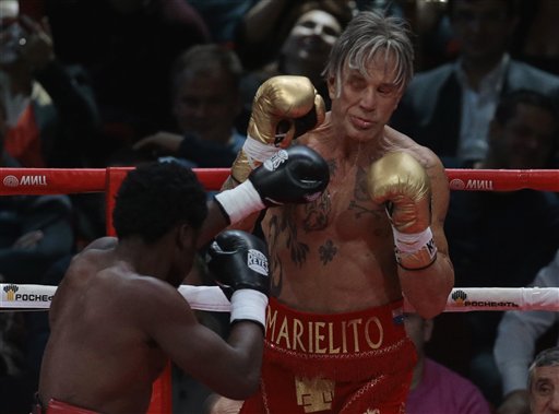 US actor Mickey Rourke, right, holds up his guard against his opponent Elliot Seymour of the United States, during their professional boxing match, at the Luzhniki Stadium, Moscow, Friday, Nov, 28, 2014. (AP Photo/Ivan Sekretarev)
