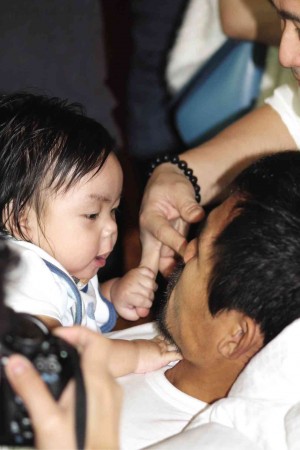 MANNY Pacquiao plays with his youngest child, Israel, in his Macau hotel suite the day after his trouble-free win over Chris Algieri Sunday. ROY LUARCA