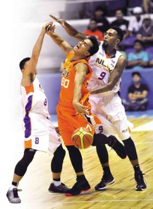 MERALCO’S Mark Macapagal (middle)  loses possession after getting jammed by an NLEX double team of Anjo Caram (left) and KG Canaleta.    photo: AUGUST DELA CRUZ