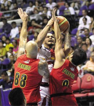 SAN MIGUEL’S Sol Mercado forces a shot off Barako Bull’s Mick Pennisi and Jeric Fortuna in yesterday’s game at the Big Dome. AUGUST DELA CRUZ
