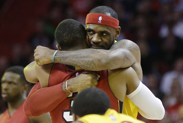 Cleveland Cavaliers forward LeBron James, right, hugs Miami Heat guard Dwyane Wade before an NBA basketball game, Thursday, Dec. 25, 2014, in Miami. AP