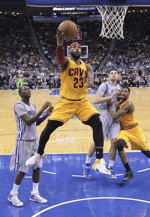 Cleveland Cavaliers' LeBron James (23) goes to the basket as he gets past Orlando Magic's Victor Oladipo, left, during the second half of an NBA basketball game, Friday, Dec. 26, 2014, in Orlando, Fla. Cleveland won 98-89. AP