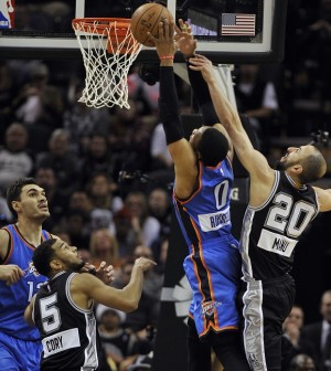 Oklahoma City Thunder guard Russell Westbrook (0) shoots against San Antonio Spurs guard Manu Ginobili (20), of Argentina, as Spurs' Cory Joseph and Thunder's Steven Adams, left, look on, in the first half of an NBA basketball game, Thursday, Dec. 25, 2014, in San Antonio. Oklahoma City won 114-106.  AP