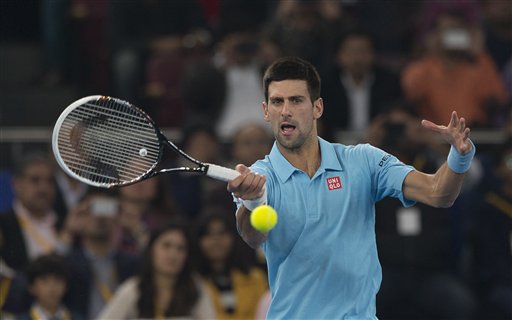 UAE Royals Novak Djokovic returns a ball to Micromax Indian Aces player Roger Federer during the International Premier Tennis League, in New Delhi, India, Monday, Dec. 8, 2014. AP