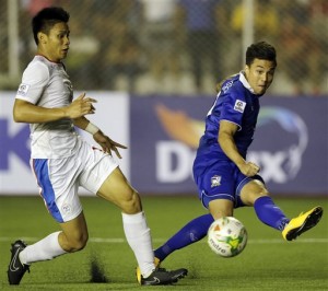 Thailand's Charyl Yannic Chappuis, right, attempts to score past Philippines' Manuel Santos Aguinaldo during the Asean Football Federation Suzuki Cup final rounds group at the Rizal Memorial Football Stadium in Manila on Saturday Dec. 6, 2014. The Philippine Azkals got bundled out in the semifinal round, this time by a young and hungry Thailand side which proved too classy and came away with a masterful 3-0 victory at Rajamangala Stadium in Bangkok on Wednesday, Dec. 11.  AP PHOTO/BULLIT MARQUEZ