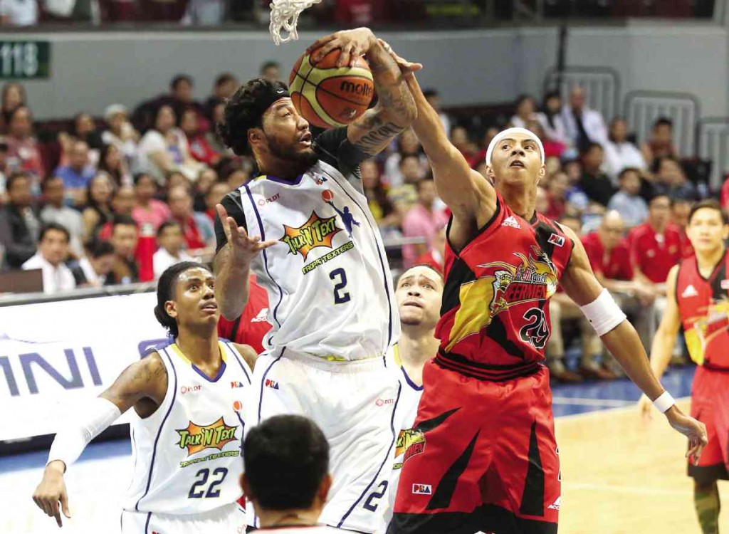 SAN MIGUEL Beer’s Arwind Santos (right) thwarts Talk ‘N Text’s Jay Washington in last night’s game still being played at press time. MARIANNE BERMUDEZ
