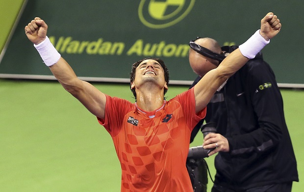 David Ferrer of Spain celebrates his win over Tomas Berdych of Czech Republic in the final of the Qatar Open at the Khalifa tennis complex in Doha, Qatar, Saturday, Jan. 10, 2015. (AP Photo/Osama Faisal)