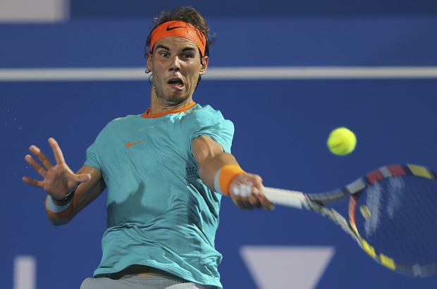 Spain's Rafael Nadal returns the ball against Britain's Andy Murray on the second day of the Mubadala World Tennis Championship in Abu Dhabi, United Arab Emirates, Friday, Jan. 2, 2015. AP
