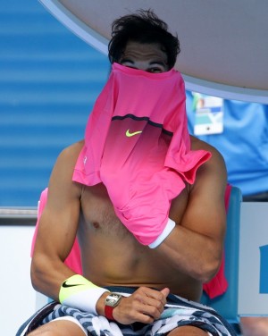 Rafael Nadal of Spain changes a shirt during a break in his quarterfinal match against Tomas Berdych of the Czech Republic at the Australian Open tennis championship in Melbourne, Australia, Tuesday, Jan. 27, 2015. (AP Photo/Rob Griffith)