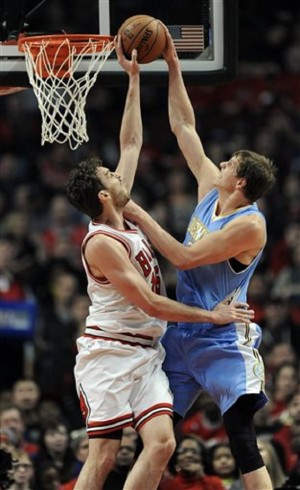 Chicago Bulls' Pau Gasol (16) blocks a shot by Denver Nuggets' Timofey Mozgov, right, of Russia, during the first half of an NBA basketball game in Chicago, Thursday, Jan. 1, 2015. Chicago won 106-101. AP