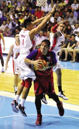 JUNE Mar Fajardo of San Miguel Beer fakes off Alaska’s Samigue Eman (left) and Cyrus Baguio in last night’s Game 7 for the Philippine Cup. The two teams were playing at press time. August dela cruz