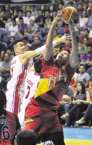 SAN MIGUEL center June Mar Fajardo (right) tries a putback against Alaska’s Cyrus Baguio (left) and Sonny Thoss during Game 1 of the Philippine Cup Finals between the Beermen and the Aces. The two teams were playing at press time. AUGUST DELA CRUZ 