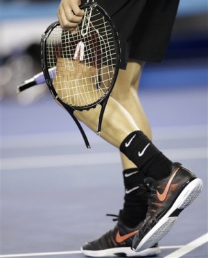 Grigor Dimitrov of Bulgaria carries away a racket which he broke during his fourth round match loss to Andy Murray of Britain at the Australian Open tennis championship in Melbourne, Australia, Monday. AP