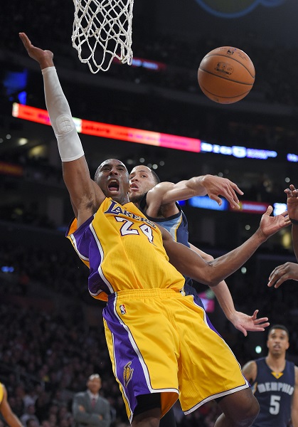 Los Angeles Lakers guard Kobe Bryant, left, tries to shoot as Memphis Grizzlies forward Tayshaun Prince knocks the ball away during the second half of an NBA basketball game, Friday, Jan. 2, 2015, in Los Angeles. AP FILE PHOTO