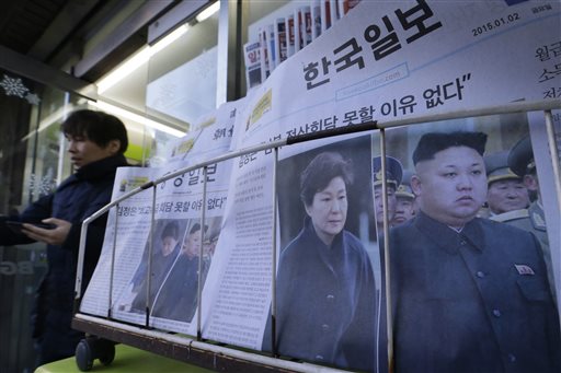 Newspapers reporting North Korean leader Kim Jong Un, right, proposed a summit with South Korean President Park Geun-hye, are sold at a store in Seoul, South Korea, Friday, Jan. 2, 2015. AP