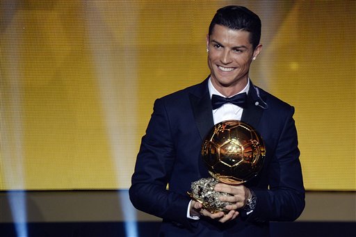 Cristiano Ronaldo of Portugal reacts after winning the FIFA Men's soccer player of the year 2014 prize at the FIFA Ballon d'Or awarding ceremony at the Kongresshaus in Zurich, Switzerland, Monday, Jan. 12, 2015.  AP PHOTO/KEYSTONE,WALTER BIERI