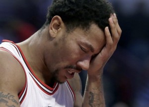 FILE- In this Nov. 10, 2014, file photo, Chicago Bulls guard Derrick Rose holds his head after being fouled during the second half of an NBA basketball game against the Detroit Pistons in Chicago. The news that Derrick Rose will have knee surgery again hit the Chicago Bulls and their fans hard and left them in a familiar spot _ trying to get by without their star point guard. The torn meniscus in his right knee was announced Tuesday night, Feb. 24, 2015, another tough twist for a franchise, a star, his sponsors and a fanbase that thought the Bulls were entering another golden era just a few years ago. (AP Photo/Charles Rex Arbogast, File)