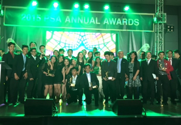 Awardees and sportswriters pose for photos on stage after the awarding ceremony.