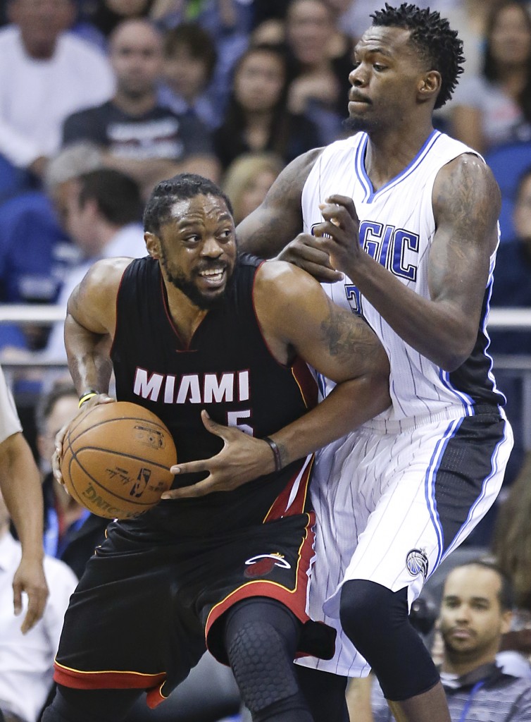 Miami Heat's Henry Walker (left) goes to the basket against Orlando Magic's Dewayne Dedmon during the second half of an NBA basketball game Wednesday, Feb. 25 in Orlando, Fla. Miami won 93-90 in overtime. AP
