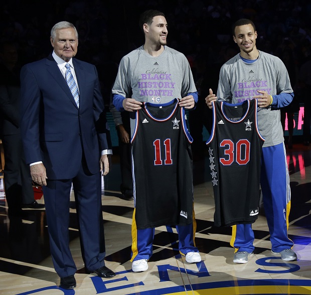 FILE - In this Feb. 4, 2015, file photo, Golden State Warriors executive Jerry West, left, presents All-Star jerseys to guards Klay Thompson (11) and Stephen Curry (30) before the team's NBA basketball game against the Dallas Mavericks in Oakland, Calif. The Warriors’ shooting tandem of Thompson and Curry will own the All-Star spotlight in New York this weekend, both competing in the 3-point contest Saturday night in Brooklyn and then playing for the Western Conference in the All-Star game Sunday night at Madison Square Garden. (AP Photo/Marcio Jose Sanchez, file)