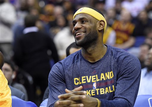 Cleveland Cavaliers forward LeBron James smiles as he sits on the bench during the second half of an NBA basketball game against the Washington Wizards, Friday, Feb. 20, 2015, in Washington. The Cavaliers won 127-89. (AP Photo/Nick Wass)