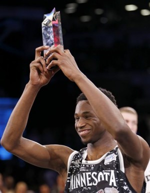 World Team's Andrew Wiggins, of the Minnesota Timberwolves, shows off his MVP trophy after NBA basketball's Rising Stars Challenge, Friday, Feb. 13, 2015, in New York. The World team defeated the U.S. team 121-112. (AP Photo/Julio Cortez)