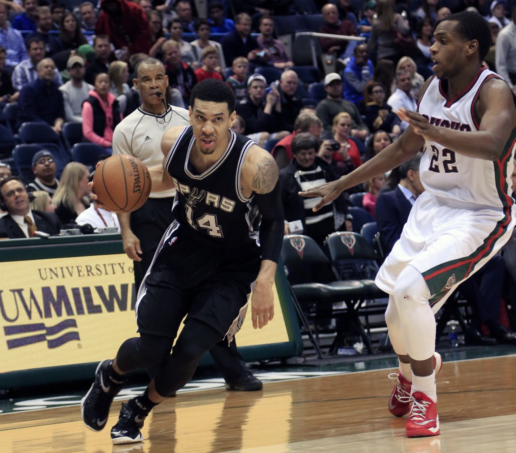 San Antonio Spurs guard Danny Green, left, drives to the basket against Milwaukee Bucks guard Khris Middleton, right, during the second half of an NBA basketball game Wednesday, March 18, 2015 in Milwaukee. The Spurs beat the Bucks 114-103. AP