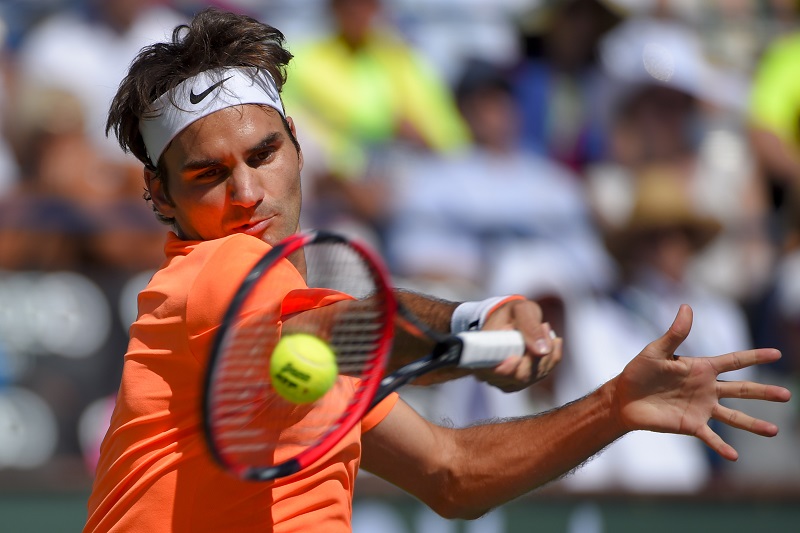 Roger Federer, of Switzerland, returns to Milos Raonic, of Canada, during their semifinal match at the BNP Paribas Open tennis tournament, Saturday, March 21, 2015, in Indian Wells, Calif. AP