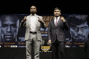 Boxers Floyd Mayweather Jr., left, and Manny Pacquiao, of the Philippines, pose for photos after a news conference, Wednesday, March 11, 2015, in Los Angeles. The two are scheduled to fight in Las Vegas on May 2. AP Photo/Jae C. Hong