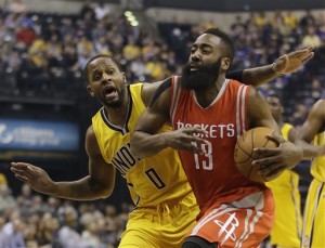 Houston Rockets' James Harden (13) goes to the basket against Indiana Pacers' C.J. Miles (0) during the first half of an NBA basketball game Monday, March 23, 2015, in Indianapolis. (AP Photo/Darron Cummings)