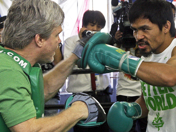Manny Pacquiao (right) spars with trainer Freddie Roach. AP FILE PHOTO