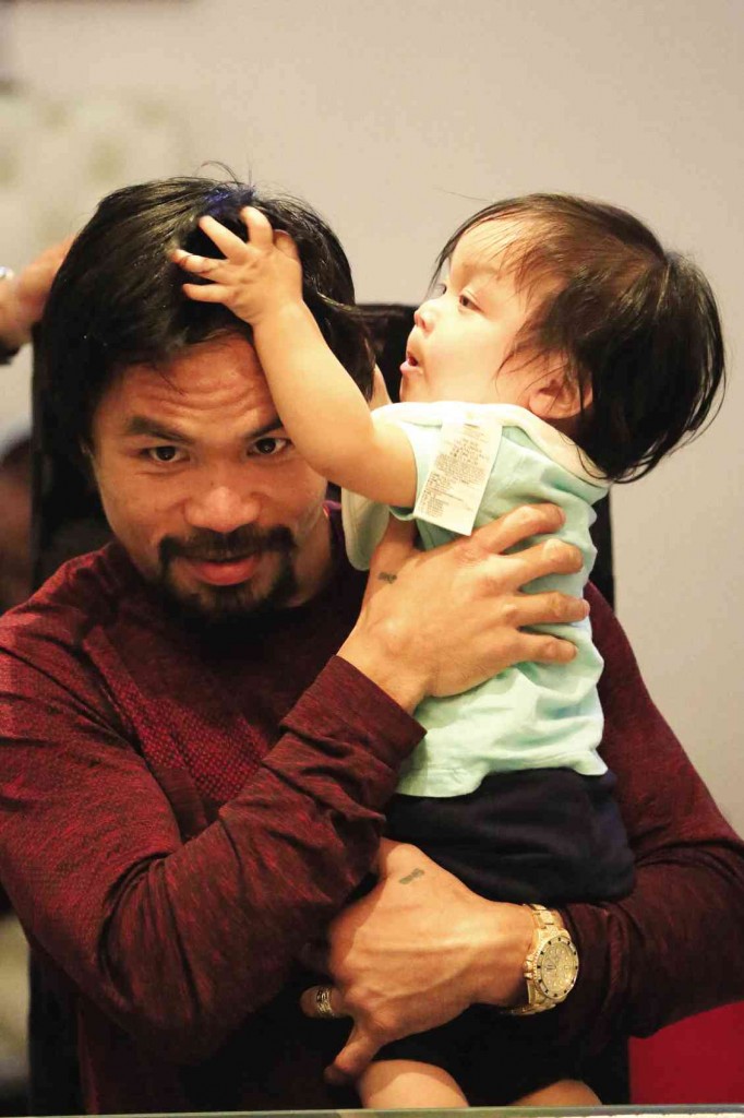 NO CONTEST At playtime in the Pacquiao Los Angeles home, the legendary champ is no match for his youngest child Israel after another day of his intensive training at Wild Card gym. REM ZAMORA
