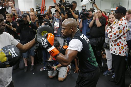 Boxer Floyd Mayweather Jr., right, works out with his uncle Roger Mayweather Tuesday, April 14, 2015, in Las Vegas. Mayweather will face Manny Pacquiao in a welterweight boxing match in Las Vegas on May 2. (AP Photo/John Locher)